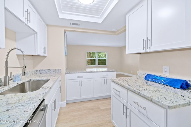 230 Columbia Dr Unit 113, Cape Canaveral, FL 32920 - kitchen featuring light wood-style floors, white cabinetry, and light stone countertops