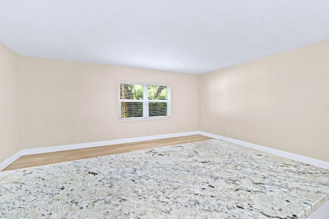 empty room featuring wood-type flooring