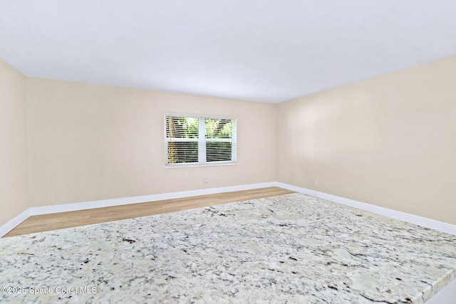230 Columbia Dr Unit 113, Cape Canaveral, FL 32920 - empty room featuring light wood-type flooring and baseboards