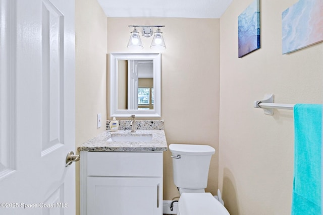 bathroom featuring vanity, a baseboard radiator, and toilet