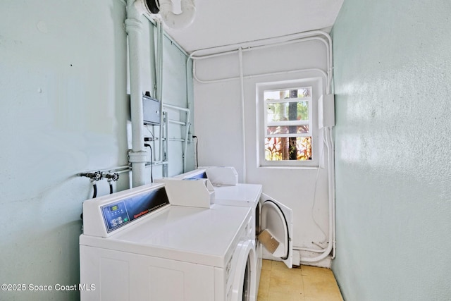 230 Columbia Dr Unit 113, Cape Canaveral, FL 32920 - community laundry featuring separate washer and dryer and light tile patterned floors