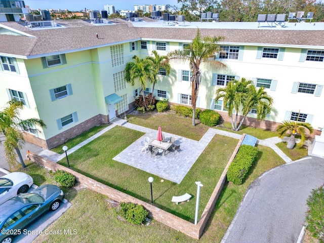 view of community with a lawn and a patio area