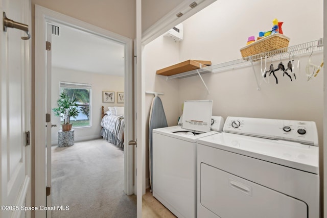 laundry area with light carpet and washer and dryer