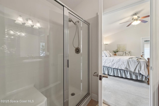 bathroom with ceiling fan, a shower with shower door, and vaulted ceiling