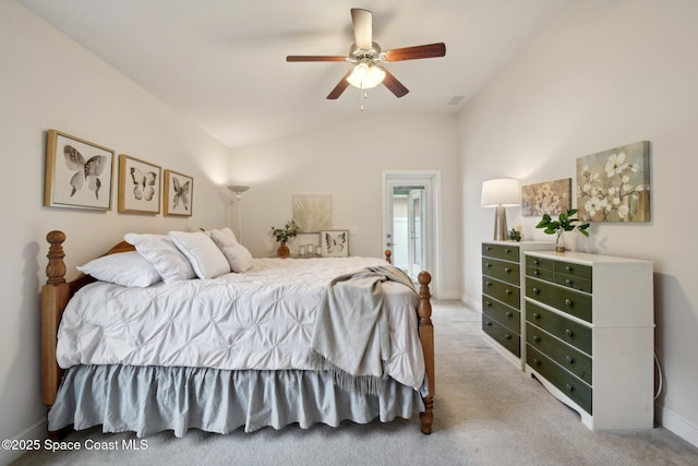 carpeted bedroom with ceiling fan and vaulted ceiling