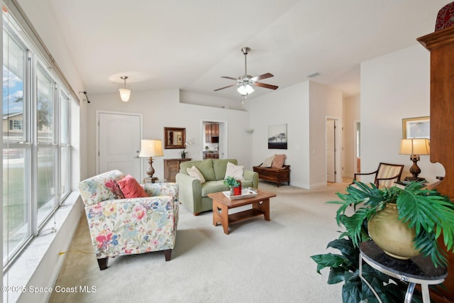 carpeted living room with vaulted ceiling and ceiling fan