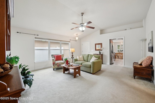 carpeted living room featuring ceiling fan and lofted ceiling