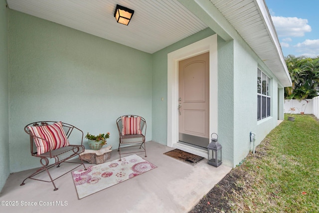 property entrance featuring a yard and a patio area