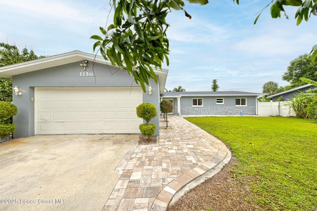 single story home featuring a garage and a front lawn