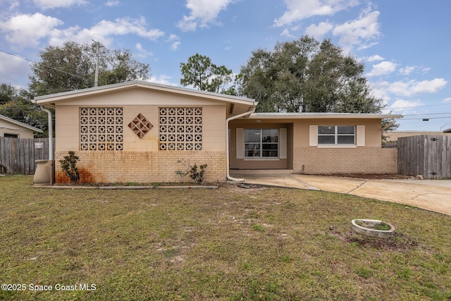 single story home with brick siding, a front yard, and fence