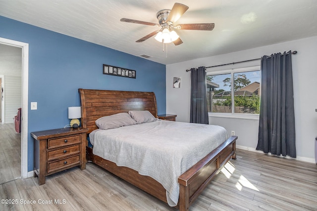 bedroom with light wood-type flooring and ceiling fan