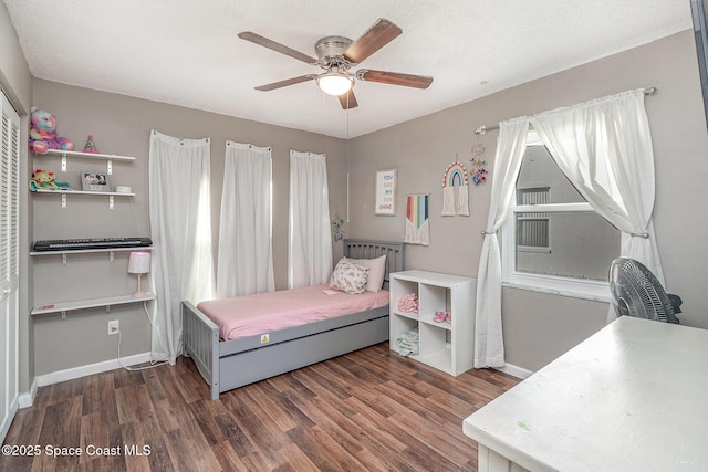 bedroom featuring ceiling fan and dark wood-type flooring