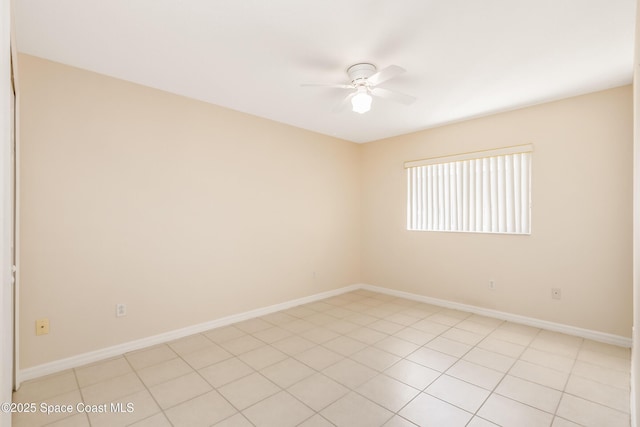 tiled spare room with ceiling fan