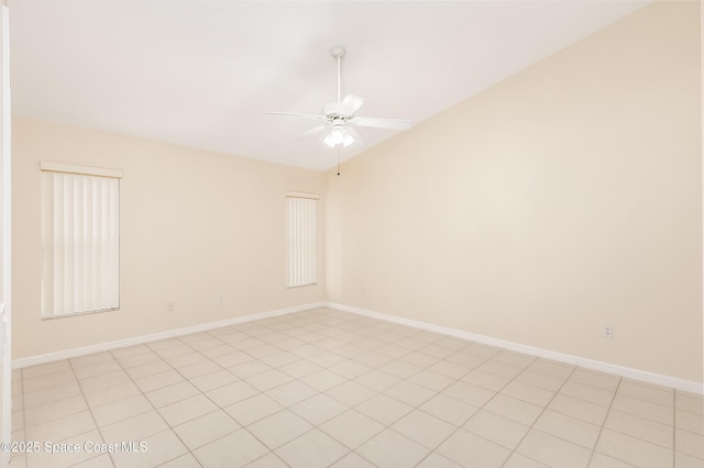 spare room with ceiling fan, light tile patterned floors, and lofted ceiling