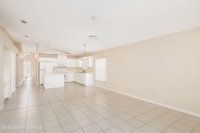 unfurnished living room with light tile patterned floors, ceiling fan, lofted ceiling, and sink