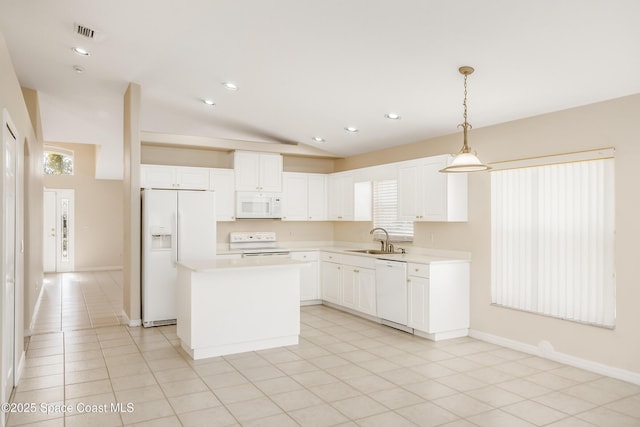 kitchen with pendant lighting, a center island, lofted ceiling, white appliances, and sink