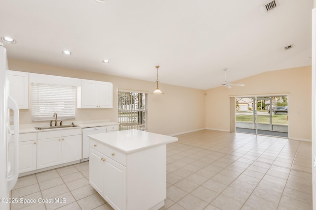 kitchen with white dishwasher, vaulted ceiling, sink, pendant lighting, and a kitchen island