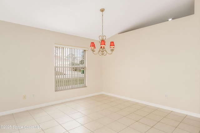 spare room featuring a notable chandelier and light tile patterned flooring