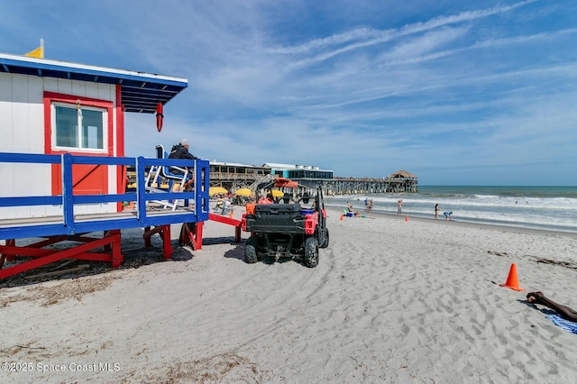 exterior space featuring a beach view and a water view