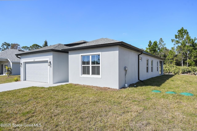 view of front of property with a garage and a front lawn