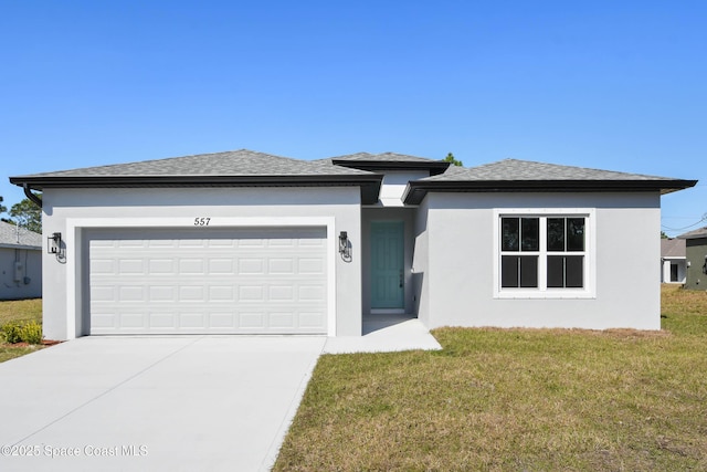 view of front of house featuring a garage and a front yard