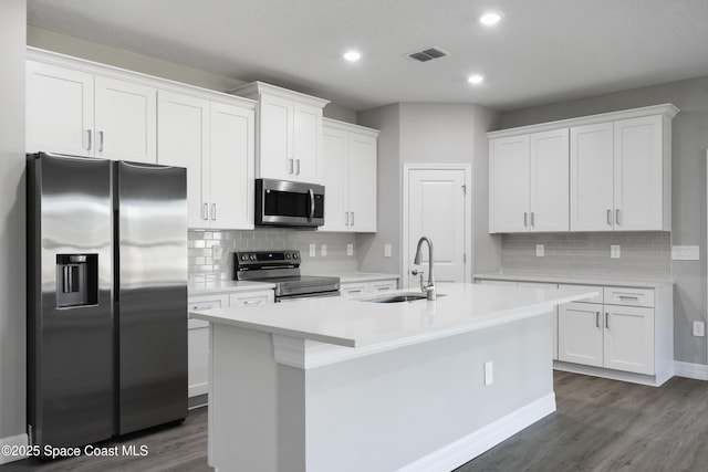 kitchen featuring white cabinetry, sink, an island with sink, and appliances with stainless steel finishes