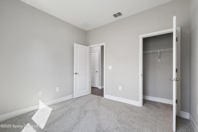 unfurnished bedroom featuring a closet and carpet