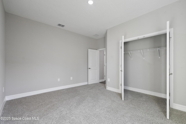 unfurnished bedroom with carpet and a closet