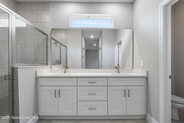 bathroom featuring vanity, an enclosed shower, and toilet