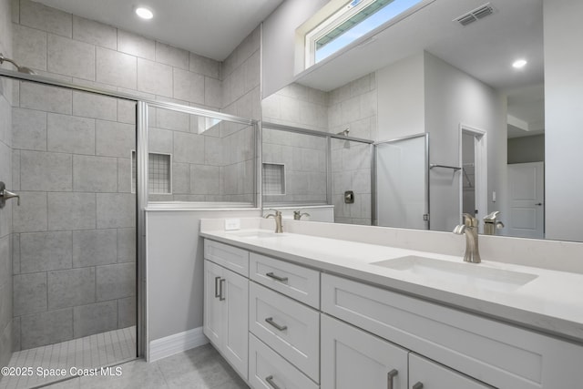 bathroom featuring vanity, an enclosed shower, and tile patterned flooring