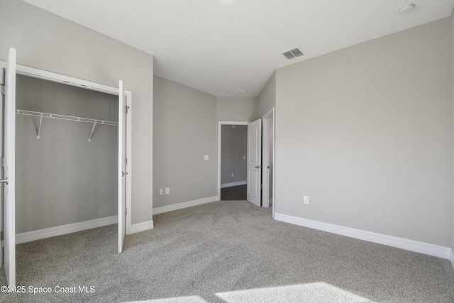 unfurnished bedroom with carpet and a closet