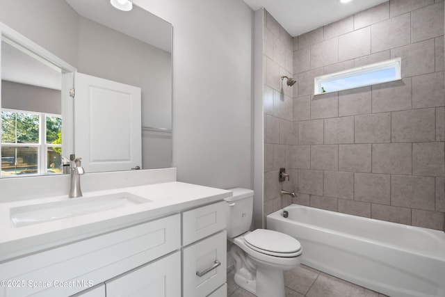 full bathroom featuring tiled shower / bath combo, vanity, a healthy amount of sunlight, and tile patterned floors