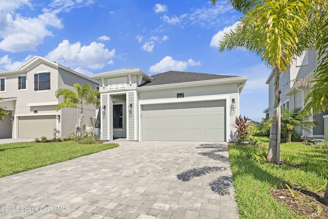 view of front of property with a front yard and a garage