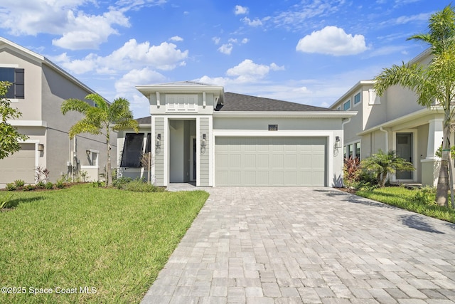 view of front of home with a garage and a front lawn