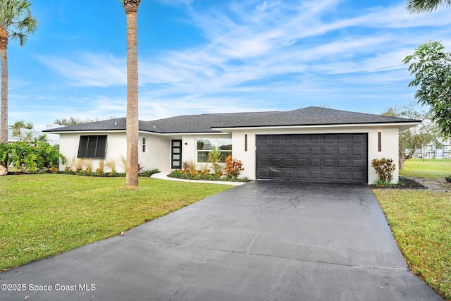 single story home featuring a front yard and a garage