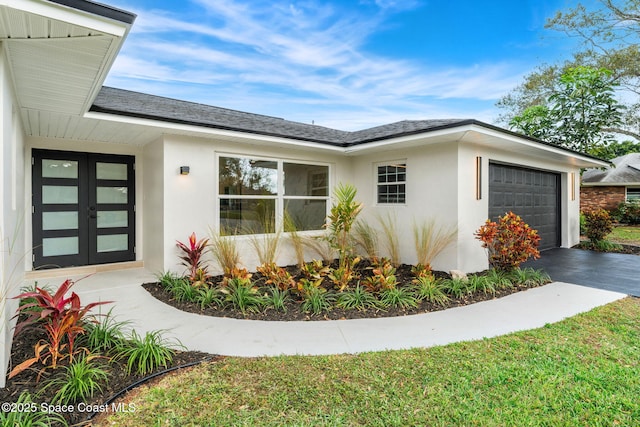 view of home's exterior featuring french doors and a garage