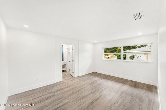 spare room featuring light hardwood / wood-style floors