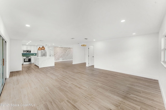 unfurnished living room with light hardwood / wood-style floors