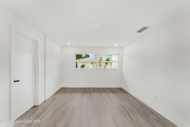 empty room with light hardwood / wood-style floors