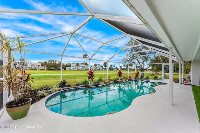 view of swimming pool with a lawn, a patio area, and glass enclosure