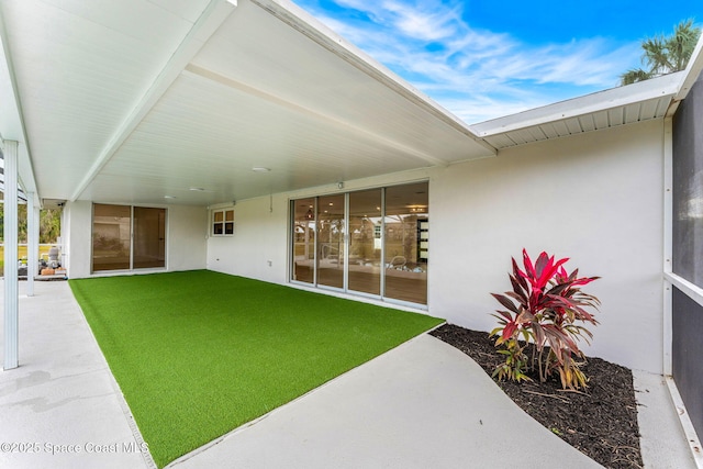 rear view of property featuring a yard