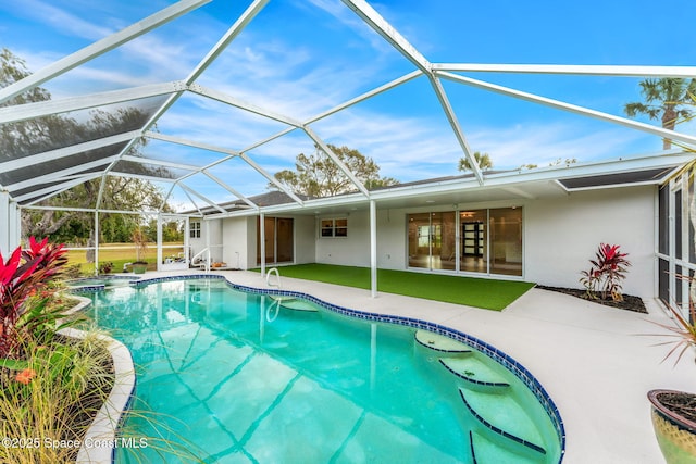 view of swimming pool with glass enclosure and a patio area