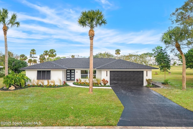 ranch-style house with a garage, french doors, and a front lawn