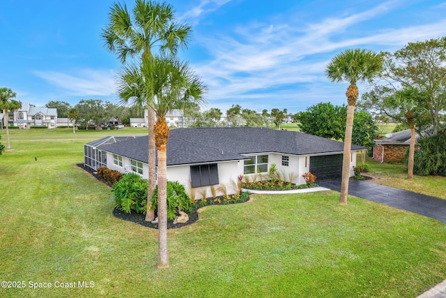 ranch-style home with a front lawn and a garage