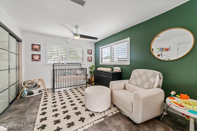 interior space with ceiling fan and concrete floors