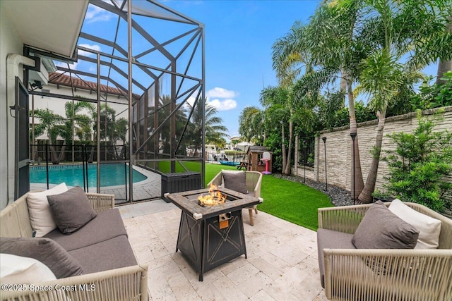 view of patio / terrace with glass enclosure, a fenced in pool, and an outdoor living space with a fire pit