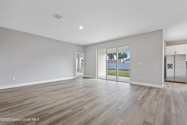 unfurnished living room with light hardwood / wood-style floors