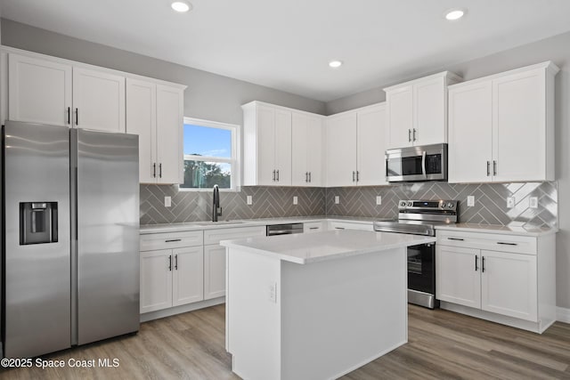 kitchen featuring white cabinets, stainless steel appliances, and sink