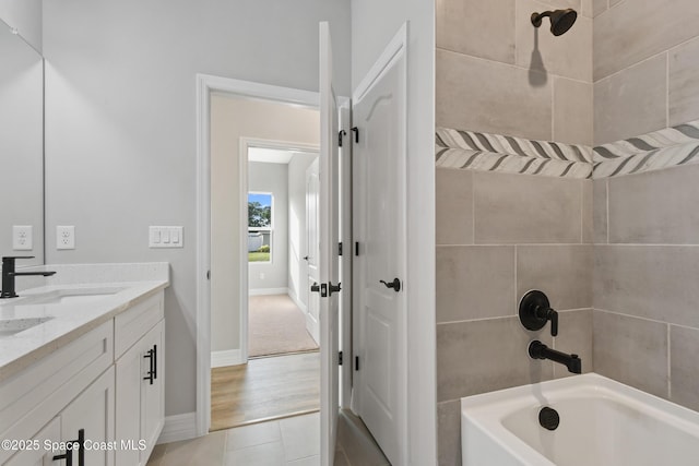 bathroom featuring tile patterned flooring, vanity, and tiled shower / bath combo