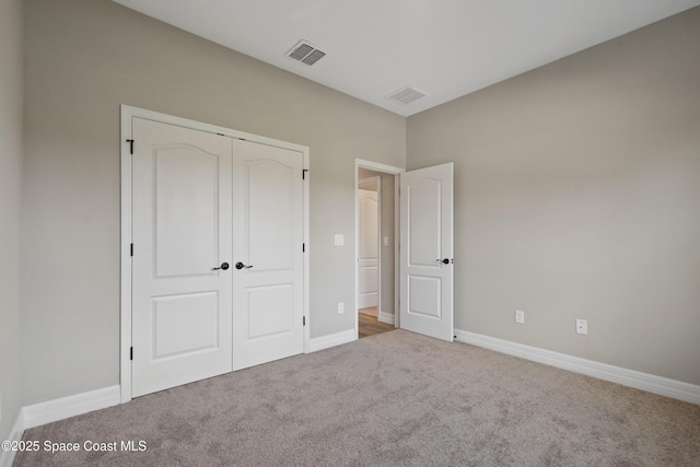 unfurnished bedroom with carpet and a closet